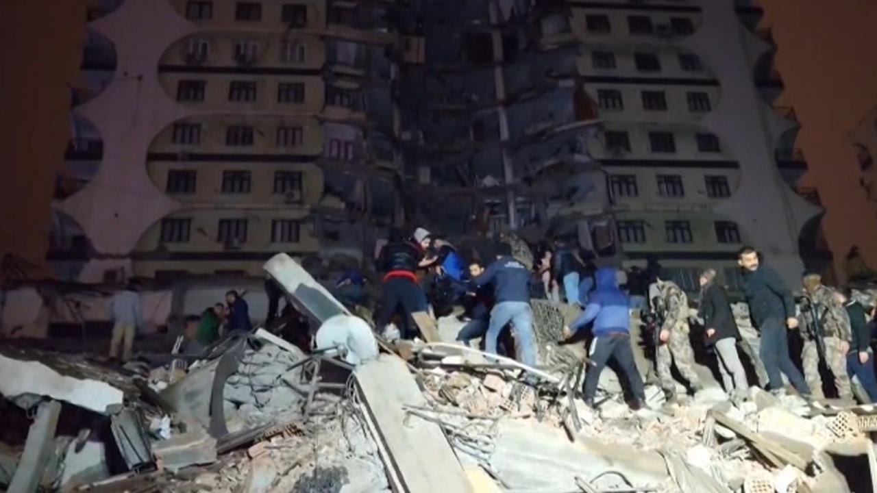 In this video grab from AFP TV taken on February 6, 2023, rescuers search for victims of a 7.8-magnitude earthquake that hit Diyarbakir, in southeastern Turkey, levelling buildings across several cities and causing damages in neighbouring Syria