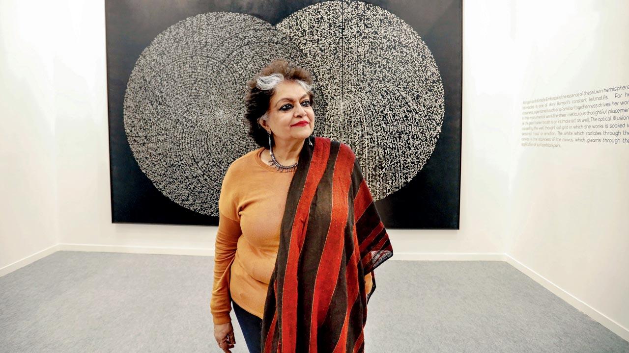 Alka Pande standing in front of a painting titled Aalingan by Anni Kumari, which shows an allegorical intimate embrace at the ongoing India Art Fair in New Delhi. Pic/Nishad Alam