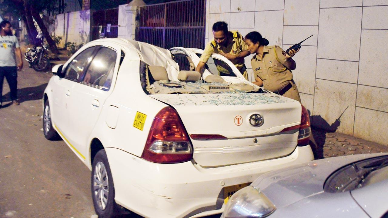 A vehicle that was damaged by the slabs at Four Seasons Residency in Worli. Pic/Ashish Raje