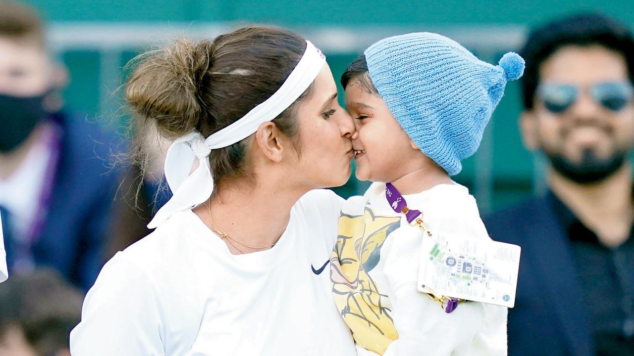 Sania Mirza celebrates with her son after winning her mixed doubles second round match against Aidan McHugh (left) and Emily Webley-Smith on Day Six  of Wimbledon 2021. Pics/Getty Images