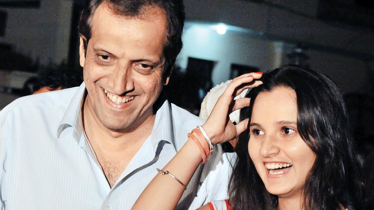 Mirza smiles as she stands next to her father, her first coach, at a press conference in Hyderabad on March 30, 2010 after she announced her wedding to Pakistani cricket star Shoaib Malik. Pic/AFP