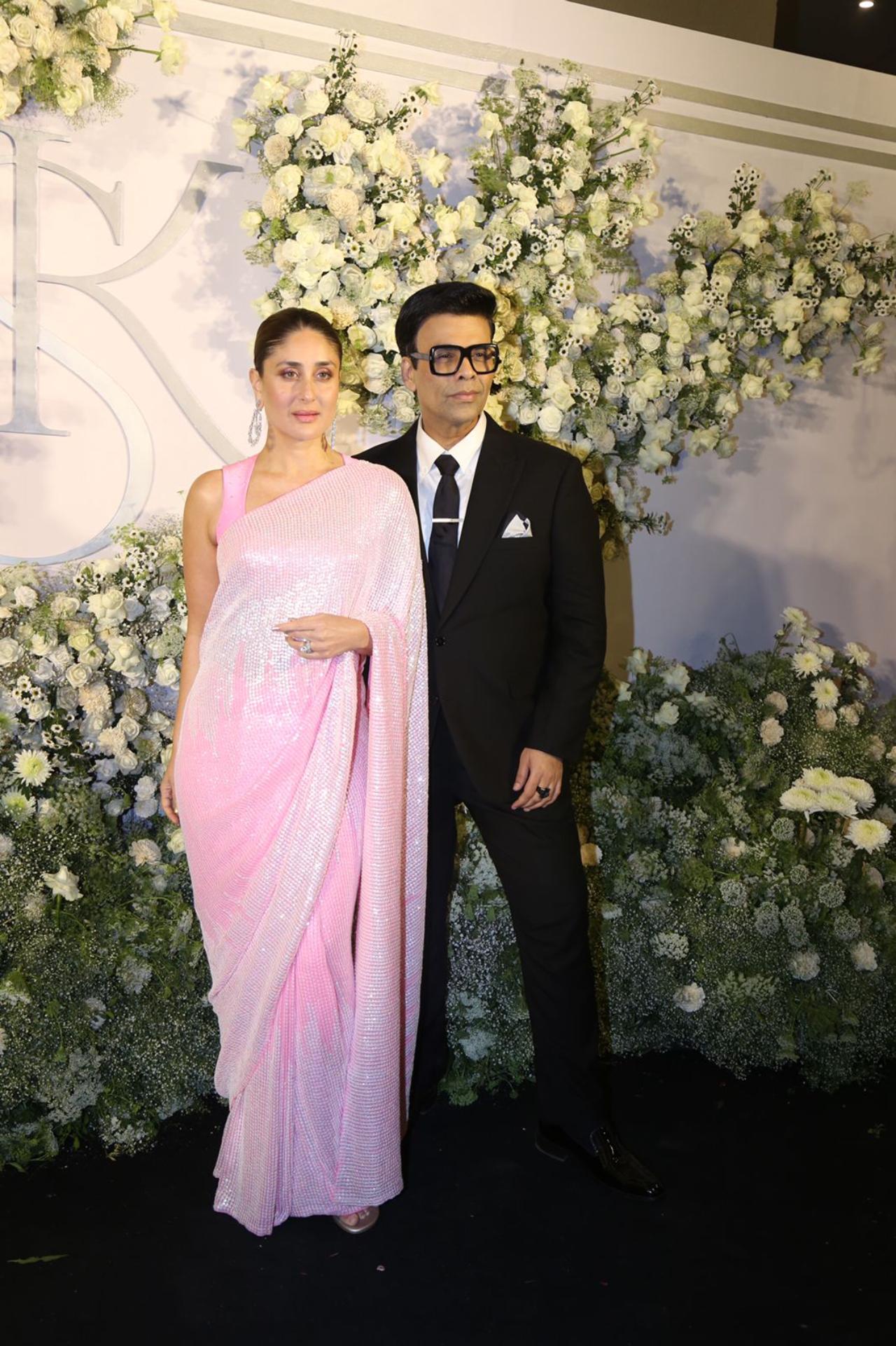 Kareena Kapoor Khan looked stunning in a pink saree. She posed with Karan Johar for the paparazzi before heading into the venue