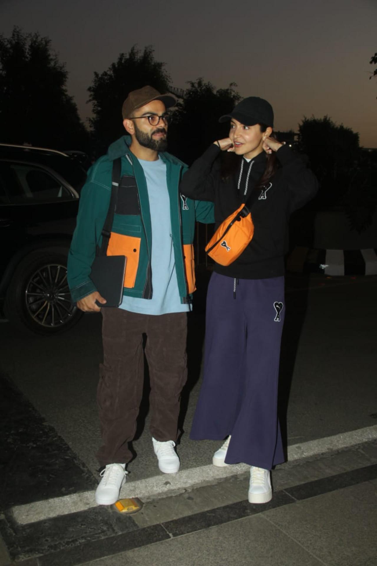Anushka was simply dressed in a black sweatshirt and purple pyjamas paired with white shoes and black cap. Virat was in a plain tee and brown cargo pants paired with a green jacket, brown cap and white shoes