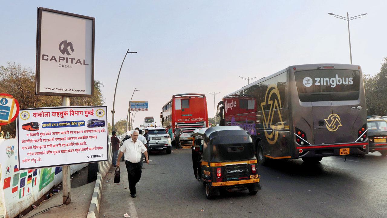 Buses and cars parked on the Western Express Highway, just ahead of the traffic department’s notice on the spot being a no-parking zone, on Wednesday