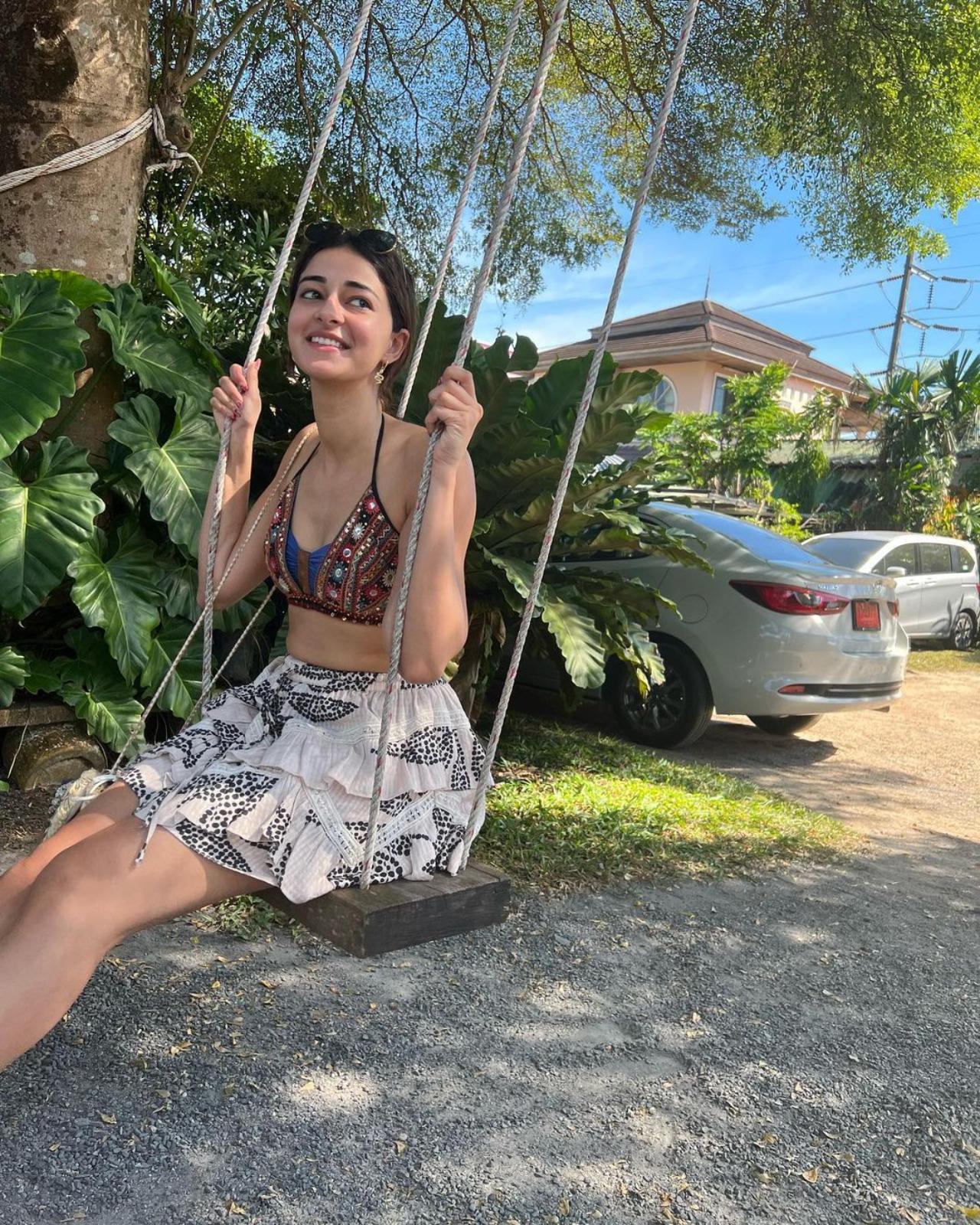 Ananya's outfit game through her vacation was surely on point. The actress opted for casual yet chic outfits for her trip. In the above, enjoying a swing is the actress in a bralette and short flowy skirt