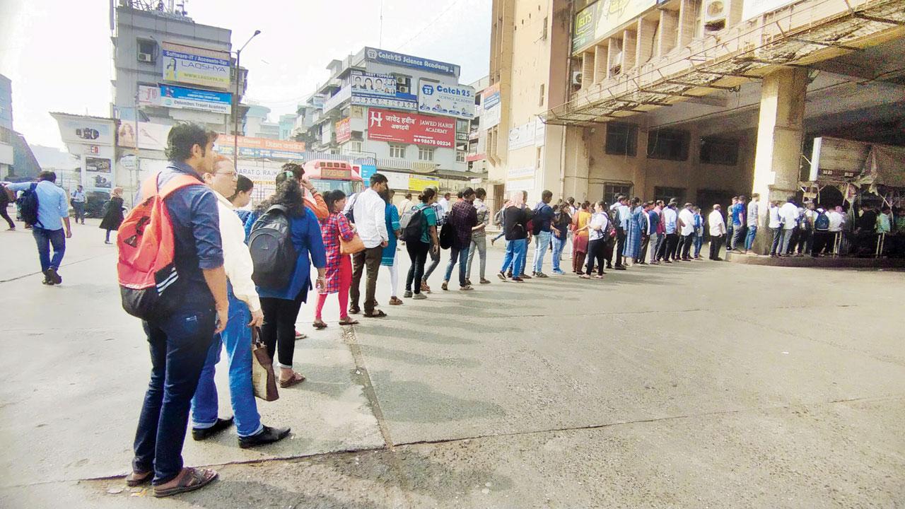 Passengers queue up to board route no. 259, at Andheri West bus station, on Monday
