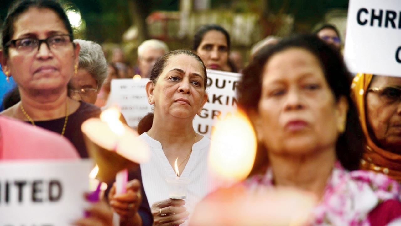 A candle-light march takes place in Bandra West. Pic/Atul Kamble