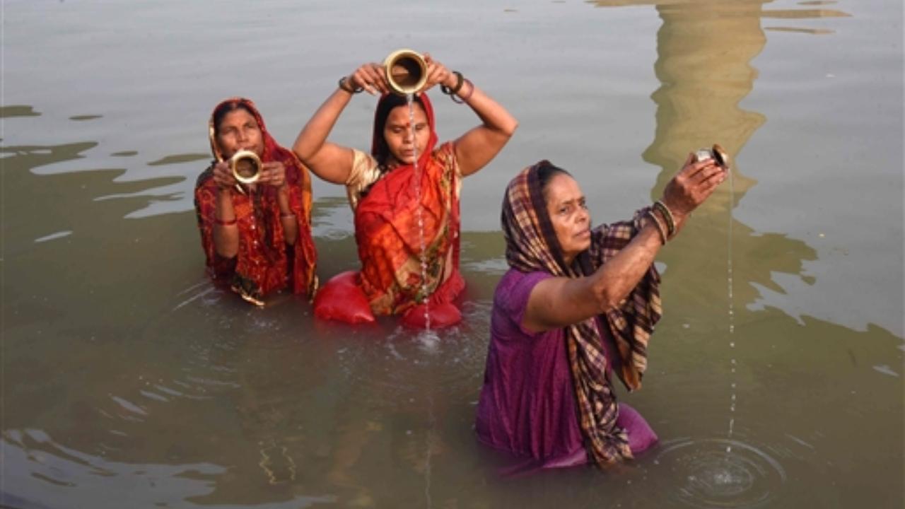 Devotees take a holy dip in the Ganga river on the occasion of the 'Makar Sankranti' festival, in Patna