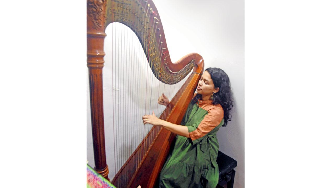 Meagan Pandian plays a tune on the harp