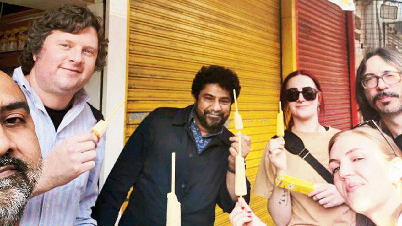 Meherwan Irani (centre) and the team pose with kulfi sticks during their street food trail in Mumbai