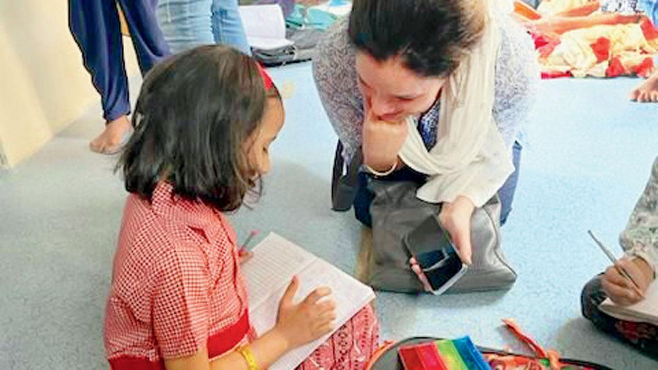 Molly Irani with a kid at Dharavi Diary