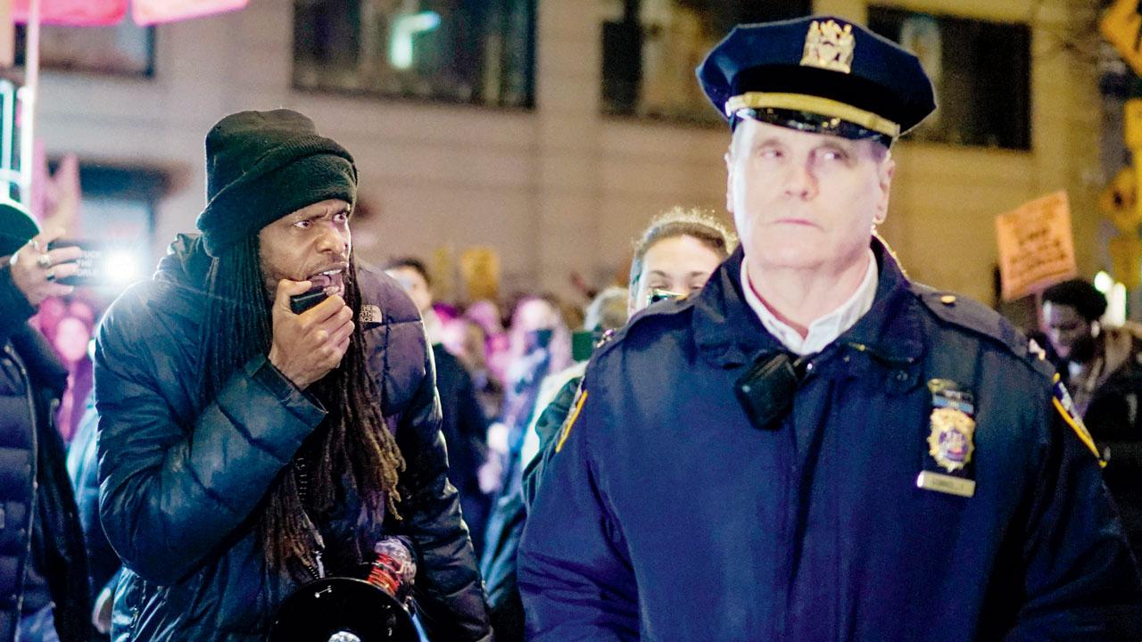 A protester shouts slogans at an NYPD officer during a rally against the fatal assault. Pic/AFP