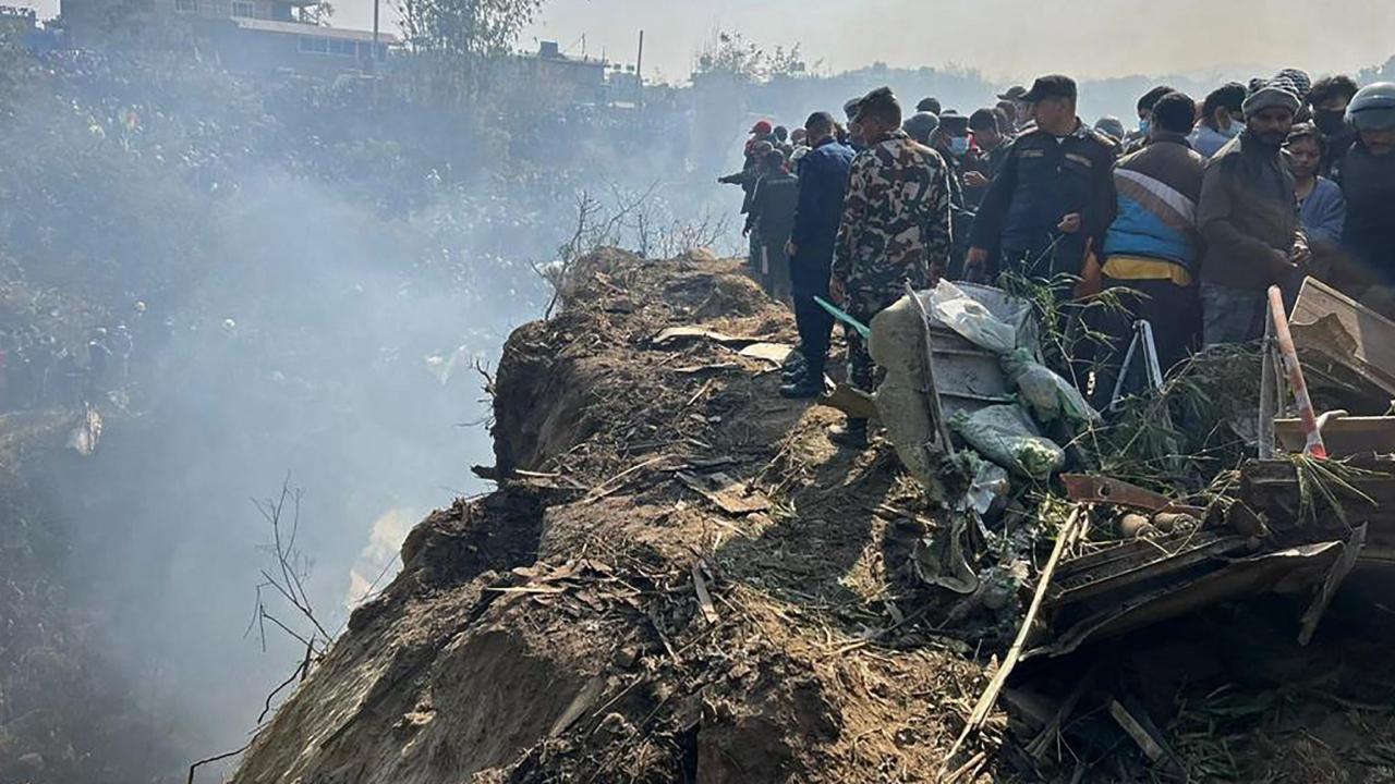 Rescuers and onlookers gather at the site of a plane crash in Pokhara. Pic/ AFP