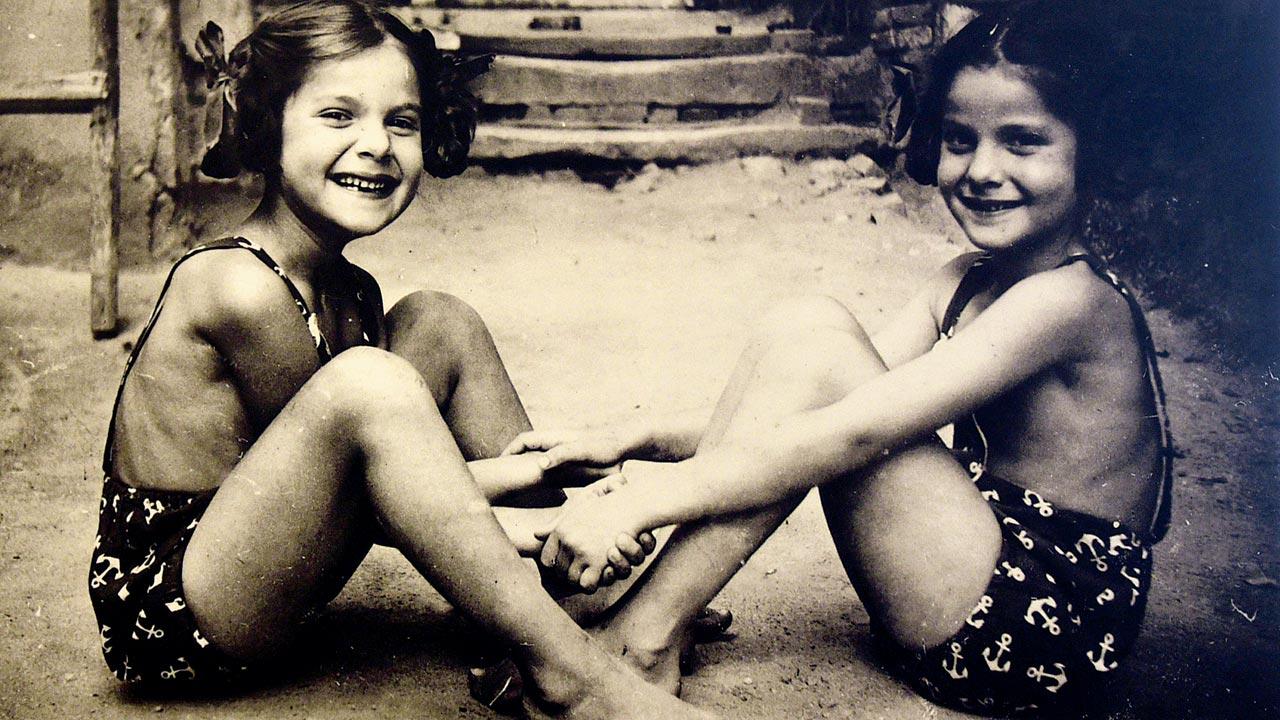 Two young girls laugh and play in a life before the Holocaust