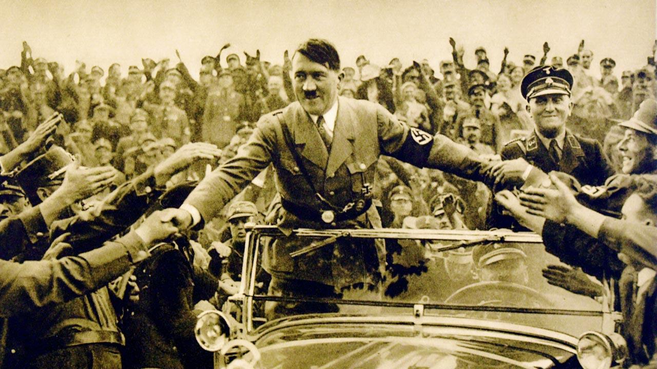 Adolf Hitler surrounded by supporters in 1930s’ Germany 