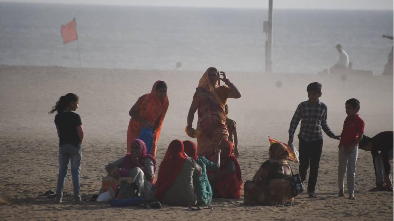 Women and children at the seashore in Mumbai on January 14.