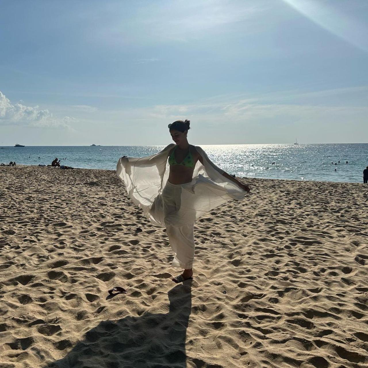 Ananya seems to have spent most of her time at the beach. In yet another picture from the beach on a seemingly sunny afternoon, Ananya can be seen twirling in a white overall over her beach wear. In the picture, she can be seen posing in front of a pristine blue sea and the inviting sand