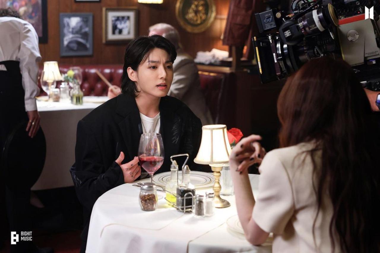 The opening shots of the 'Seven' music video feature Jungkook with 'World of the Married' actress Han So Hee. The ambient lighting and visuals perfectly capture the passionate, charged argument between them 