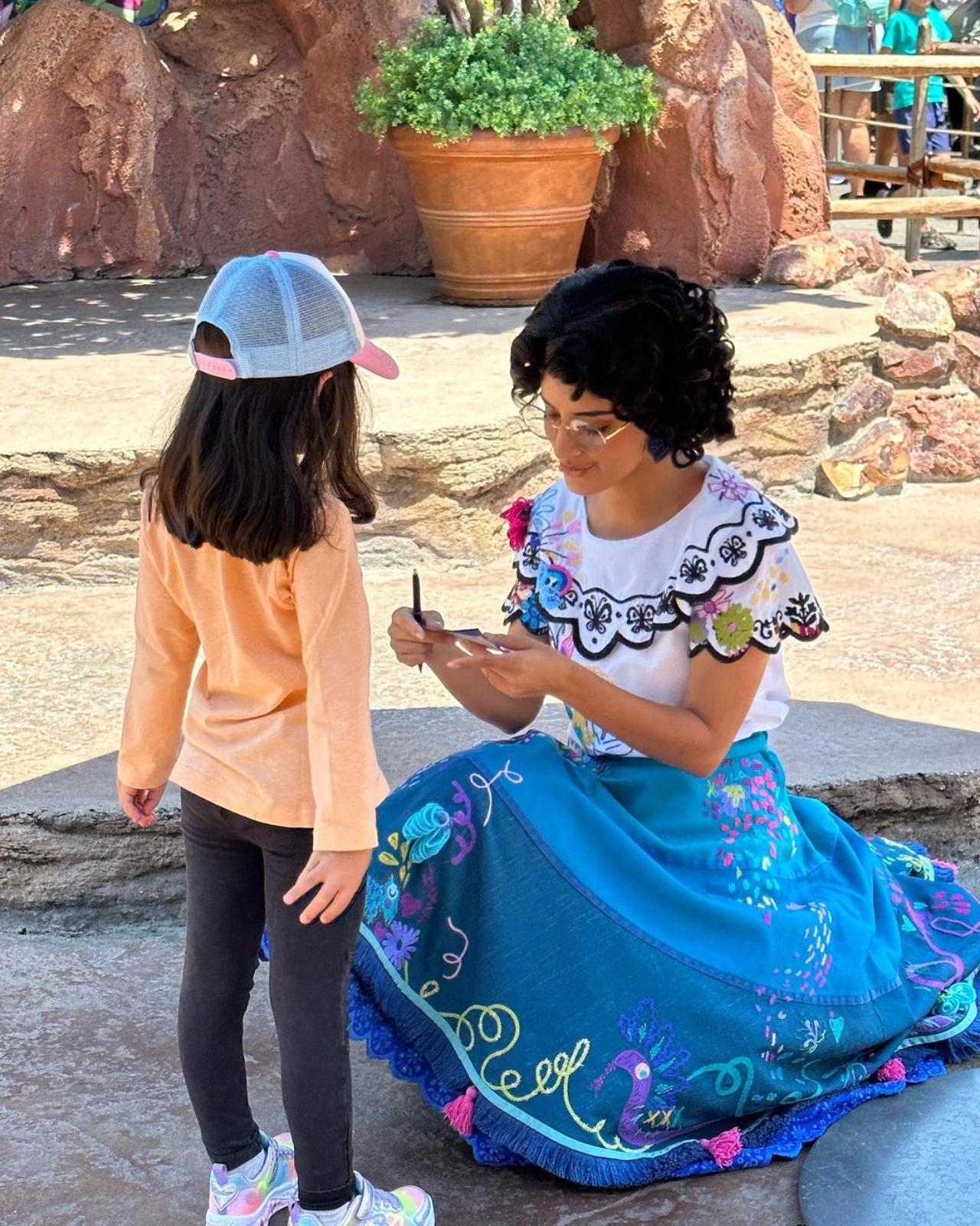 Two Disney characters in one frame - one princess granting another's wish on Disneyland streets