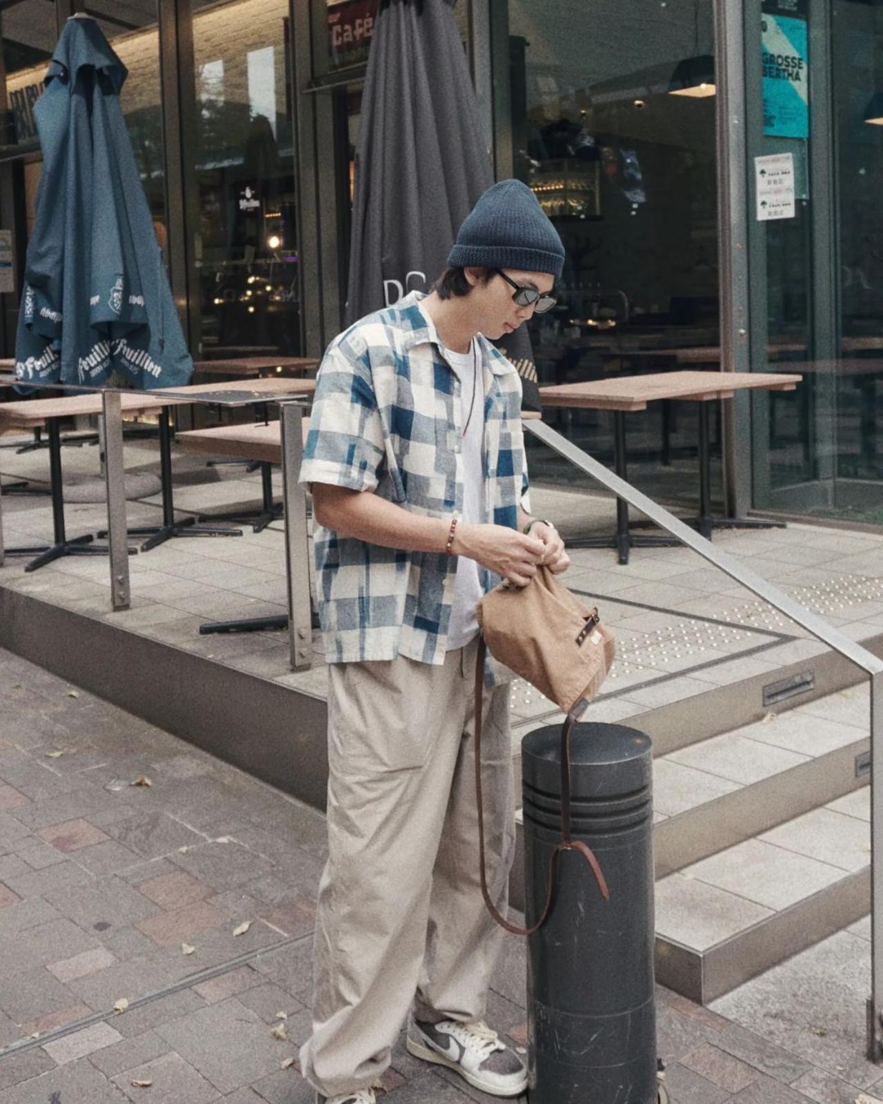 Can you tell this man loves plaid? Namjoon looks super stylish in his flannel and baggy cargo pants. Don't forget his beanie!