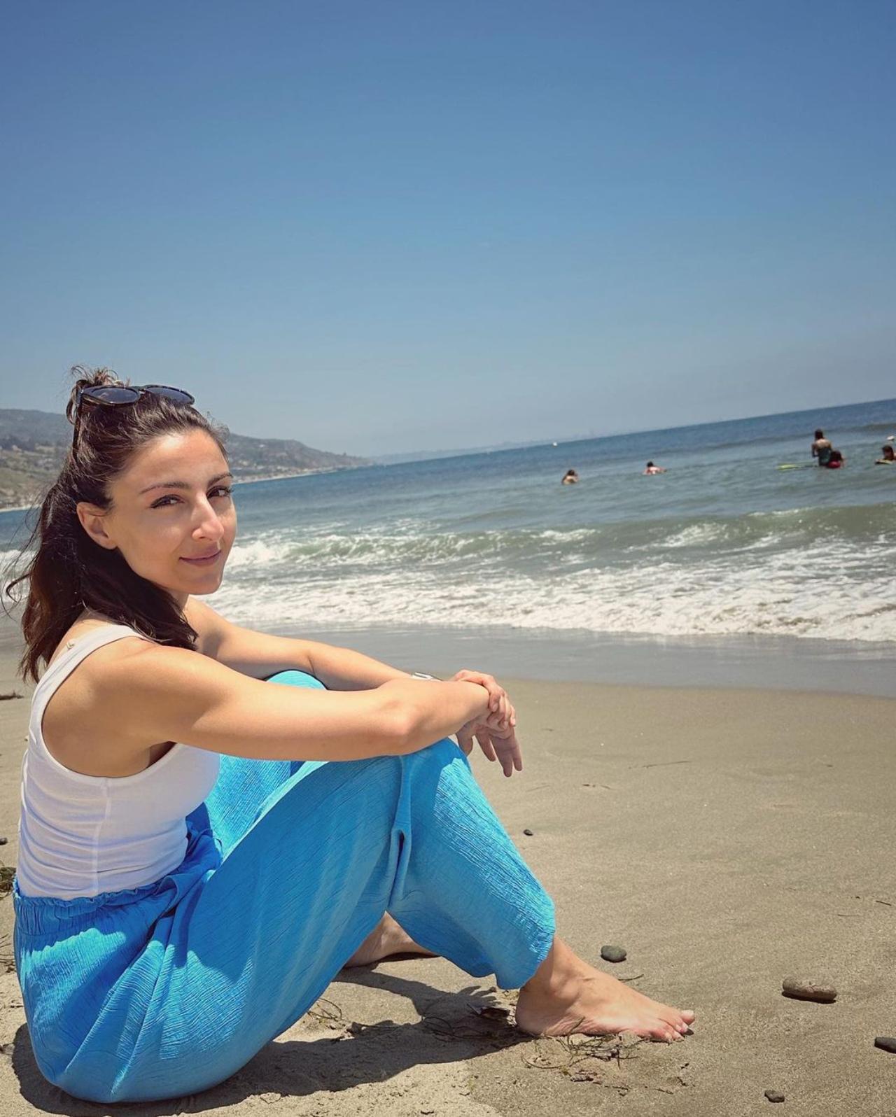 Soha is chilling by the beach - windswept hair, sand and waves - vacay mode is on!
