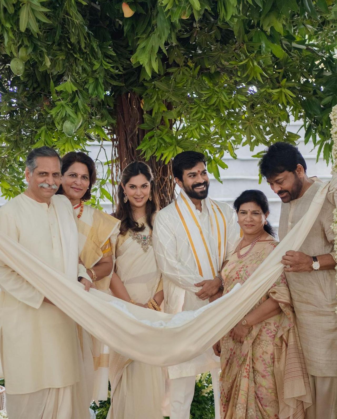 The RRR actor also shared a few photos from the ceremony. The entire family was elegantly dressed in traditional colours of white and gold. They stood behind the cradle adorned with jasmine flowers