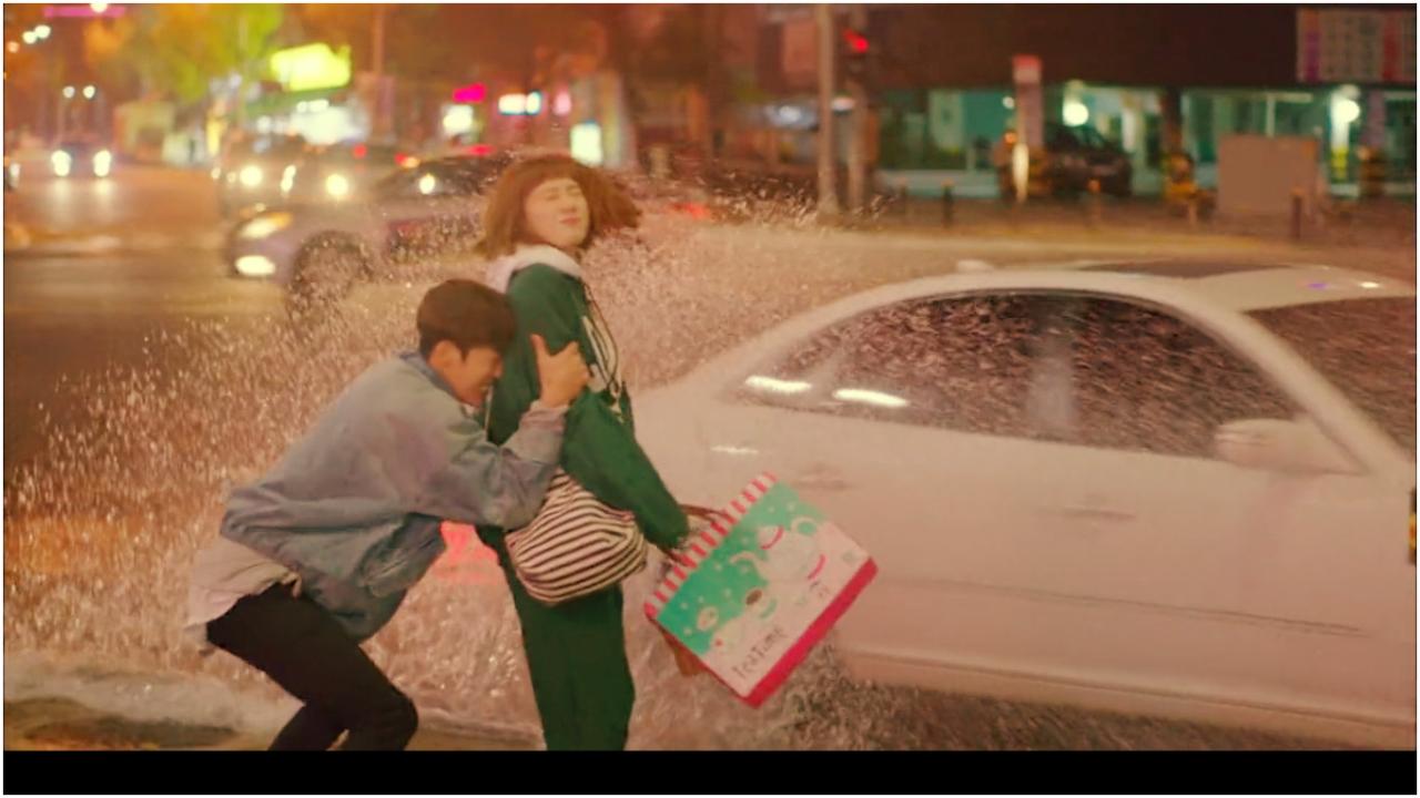 Weightlifting Fairy Kim Bok Joo
Doctor Jae Yi tries to save Kim Bok Joo from a car zipping past. A valiant attempt but the damage is done - the water from the puddle has already landed on her dress. Nevertheless, the scene serves as the catalyst to cement the bond between them