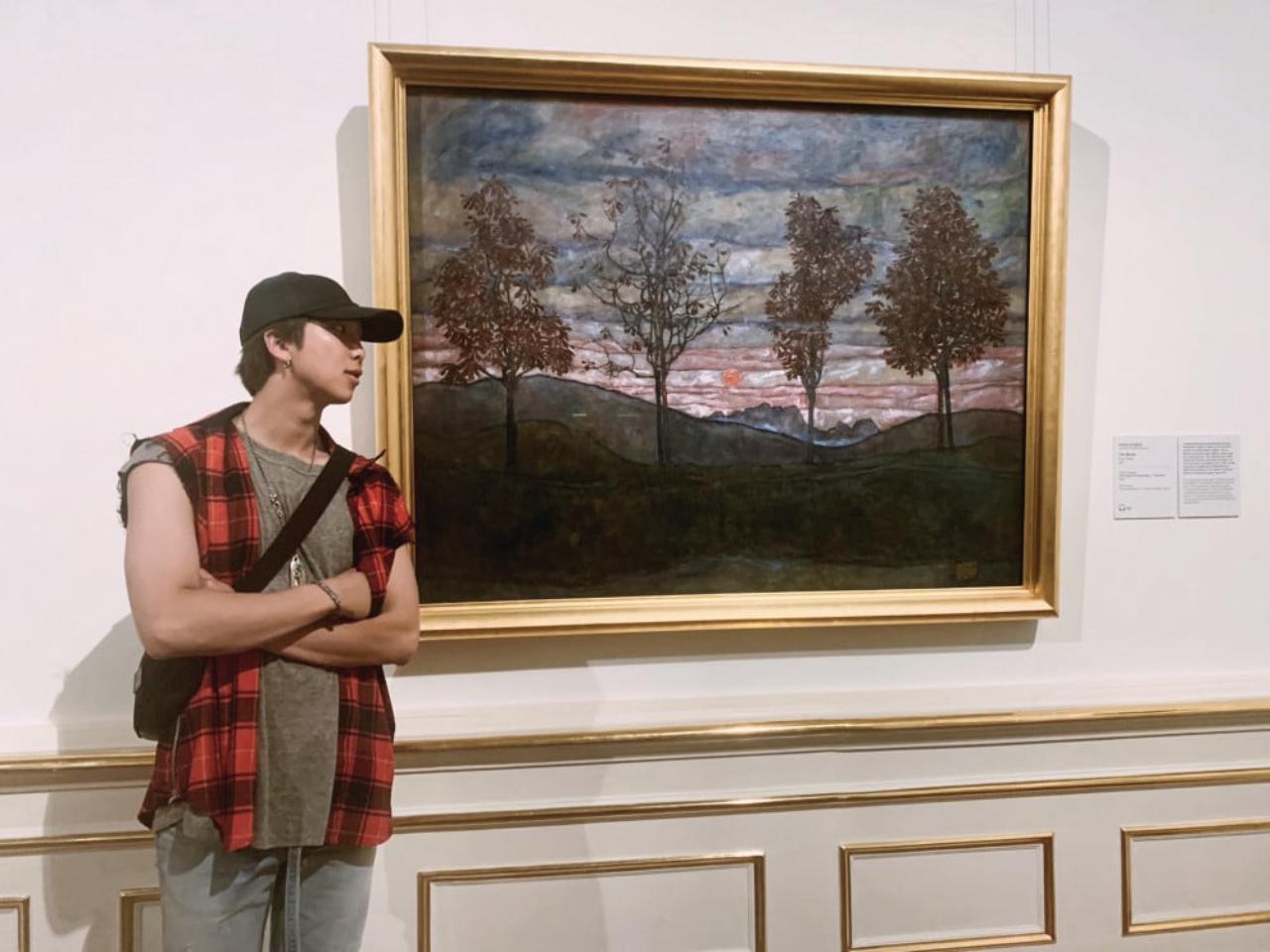 Do we look at the painting or Namjoon's sculpted arms? What is the art here, exactly?