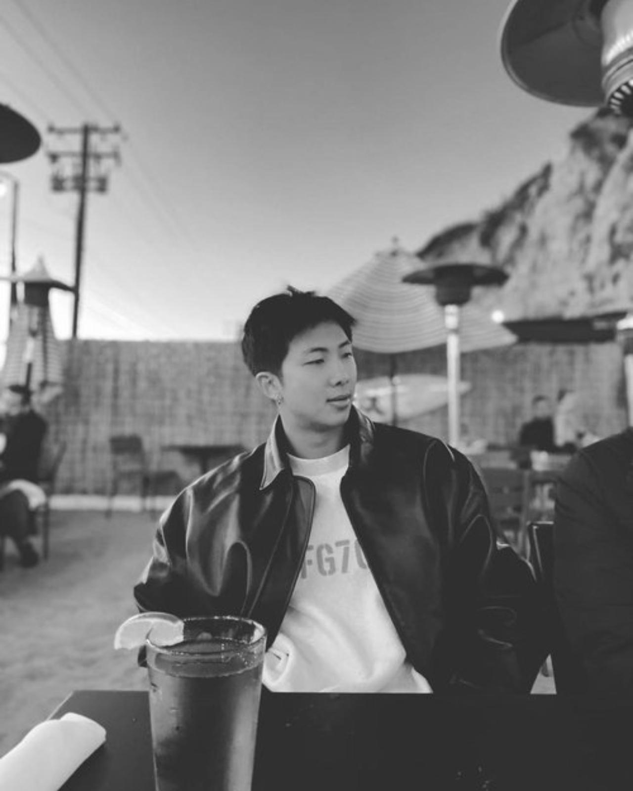 Who said Namjoon can pull off black only as long as it's a suit? The artist posted a few pictures of his time unwinding with friends at a cafe when he opened his personal Instagram account in 2021. BTS are often known for their love of Fear of God clothes - and paired with a black leather jacket, RM looks classier than ever! Perhaps, he is taking style tips from Golden Maknae, Jungkook? The monochromatic picture accentuates the play of white and black, light and shadow