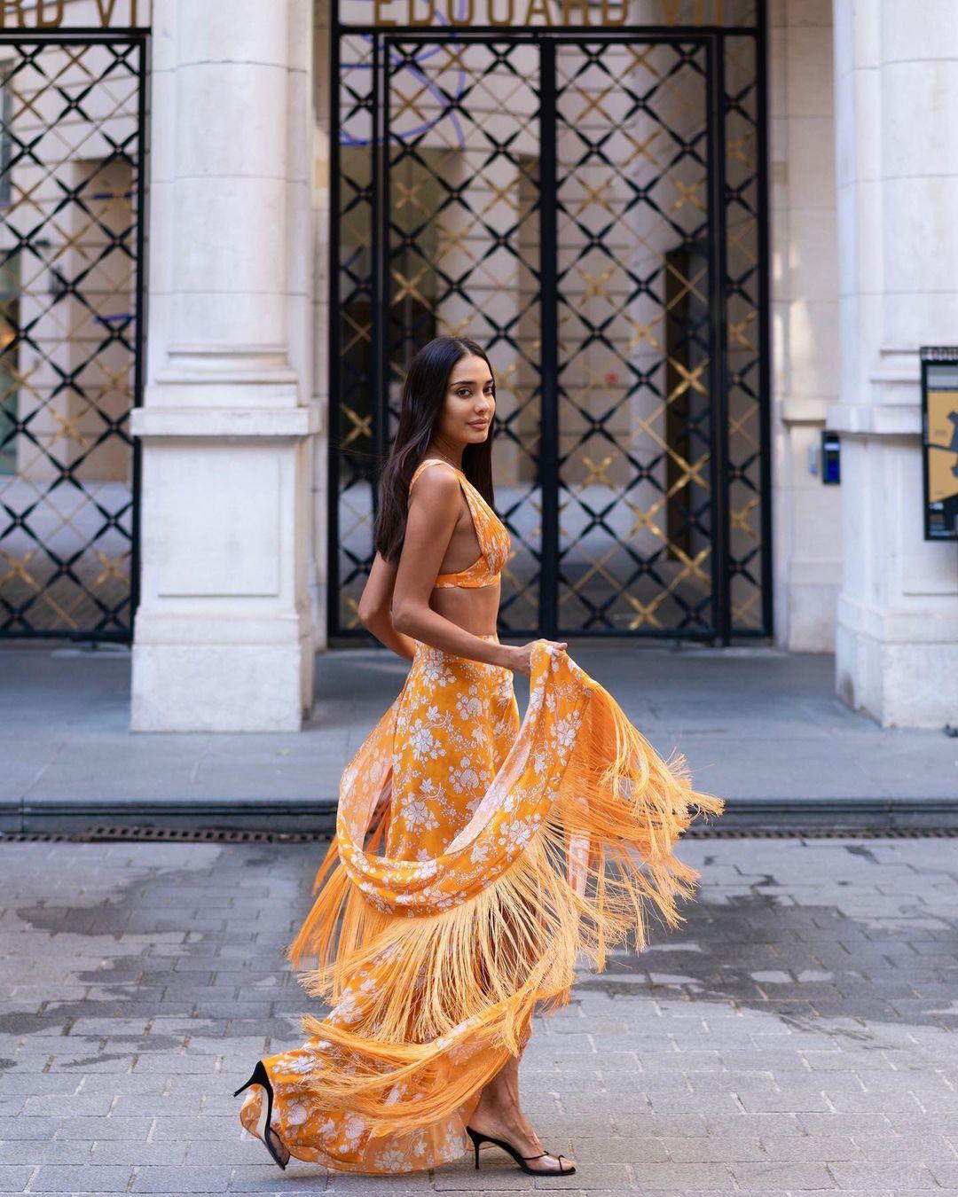 Lisa Haydon embraces summer vibes in a vibrant orange co-ord skirt set with delicate white flower prints.