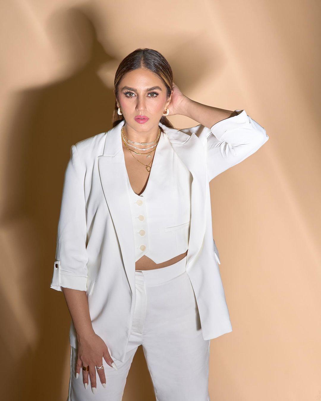 Classic and Stylish: Huma's white pantsuit is a fashion standout.