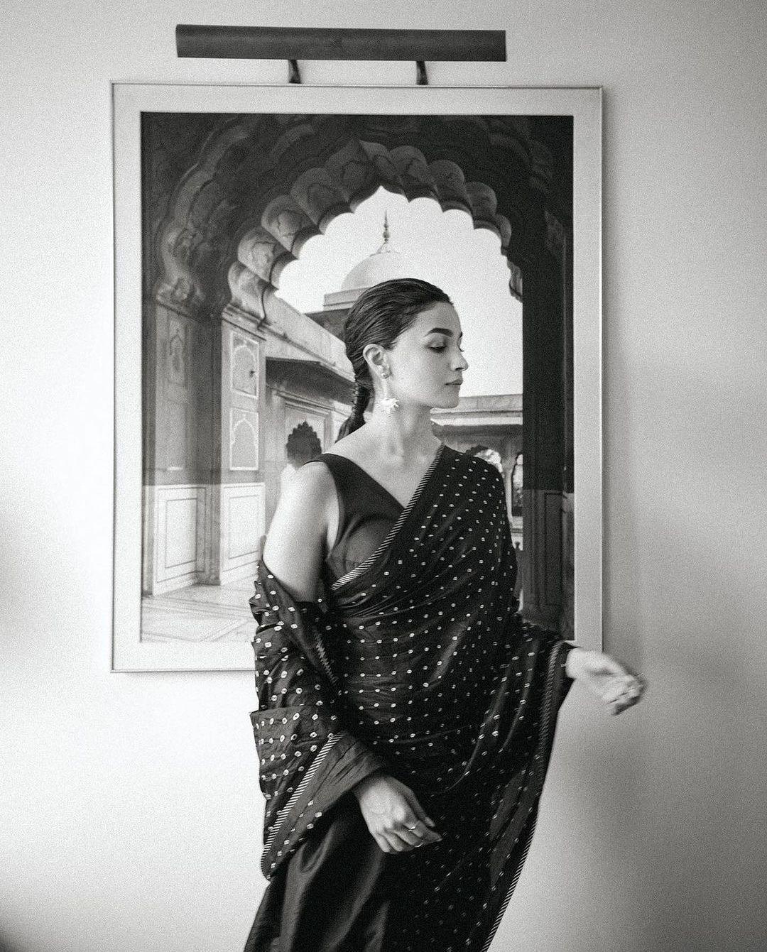 Classic Elegance: Alia Bhatt's black and white saree series illuminates her beauty, emphasized by kajal eyes and a graceful bindi.
