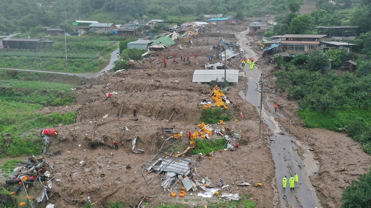 In the central city of Cheongju, hundreds of rescue workers, including divers, continued to search for survivors in a muddy tunnel where about 15 vehicles, including a bus, got trapped in a flash flood that may have filled up the passageway within minutes on Saturday evening.