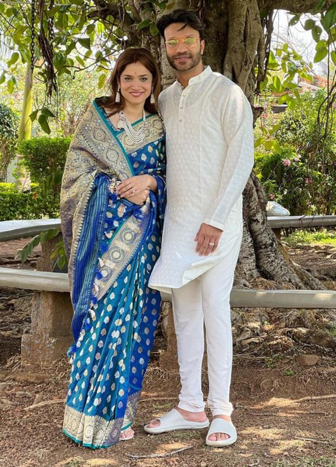 Ankita in this picture poses with her husband Vicky Jain in a printed blue saree