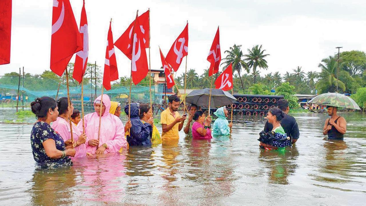 Activists and tribals protesting in waist-high water