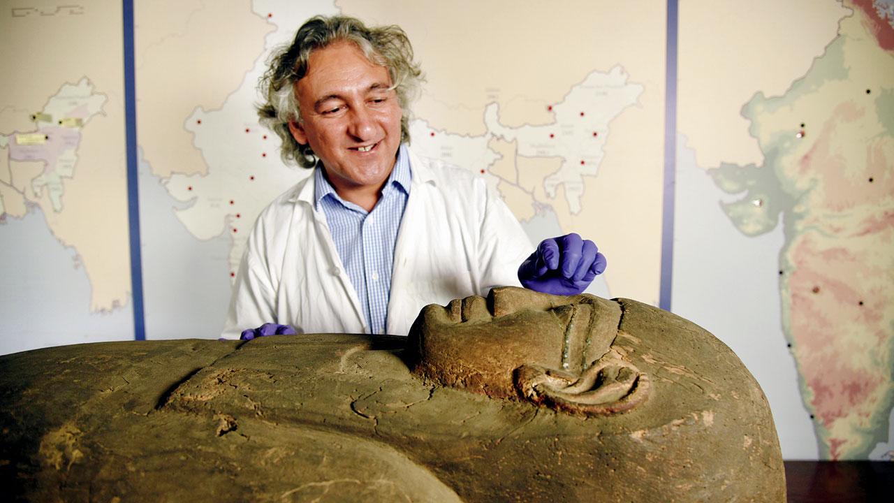 Anupam Sah points to a feature on the wooden coffin in 2016. File pic