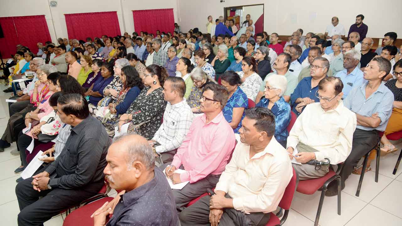 The audience listens as speakers cite arguments