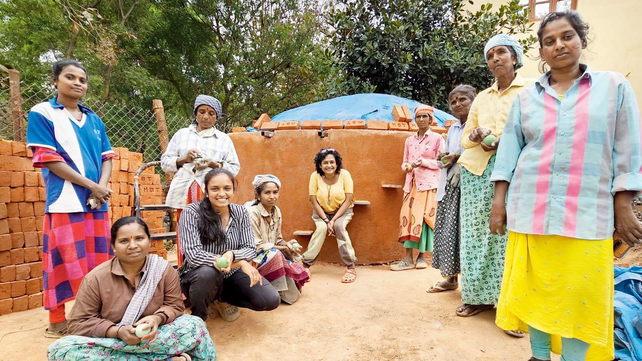 The team in front of a 16,000-litre capacity cement-free water tank they built