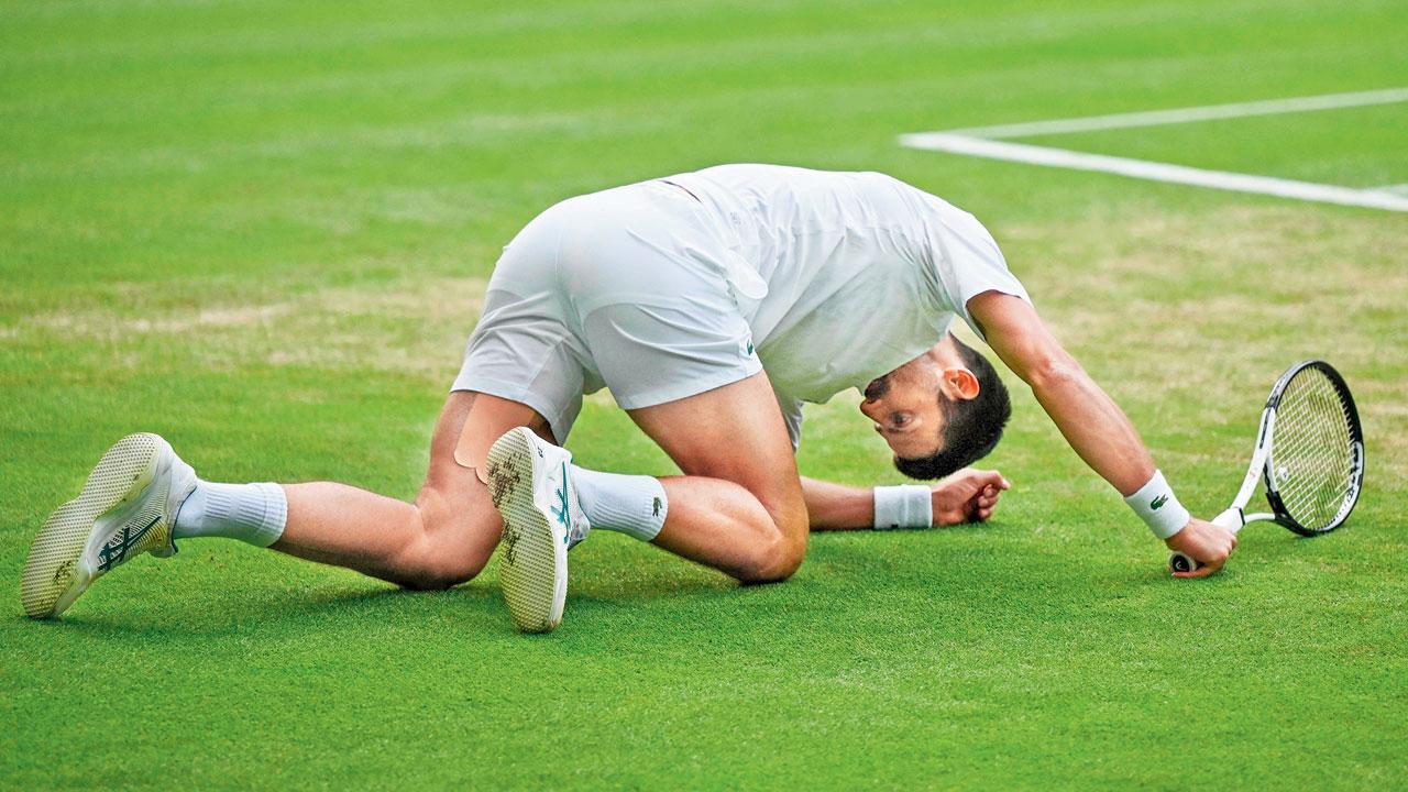 Serbia’s Novak Djokovic slips while trying to return to Spain’s Carlos Alcaraz during their Wimbledon final in London yesterday. Pics/AFP