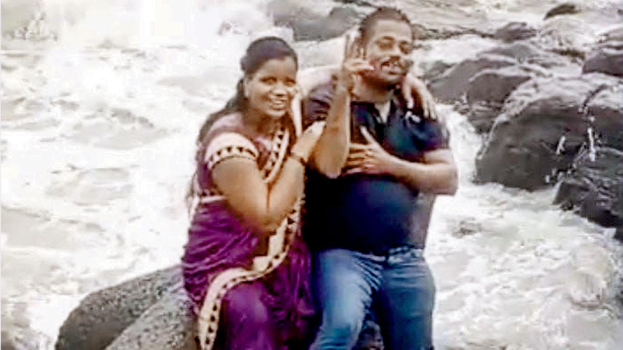 The couple poses for photographs on the rocks