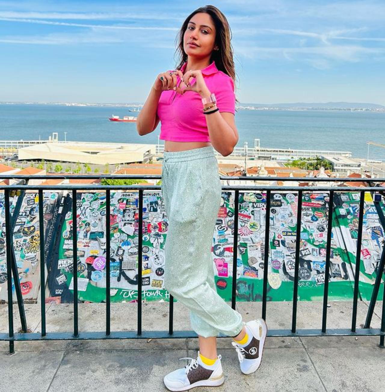 Surbhi Chandna opts for a pink crop top with textured track pants. She finished the entire look by keeping her hair open