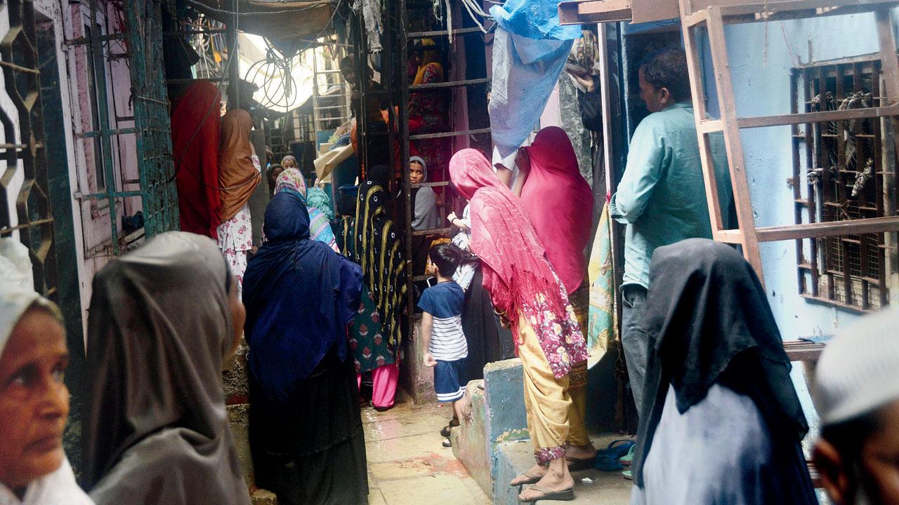 Residents gather outside Kafeel Ahmed’s house in Govandi