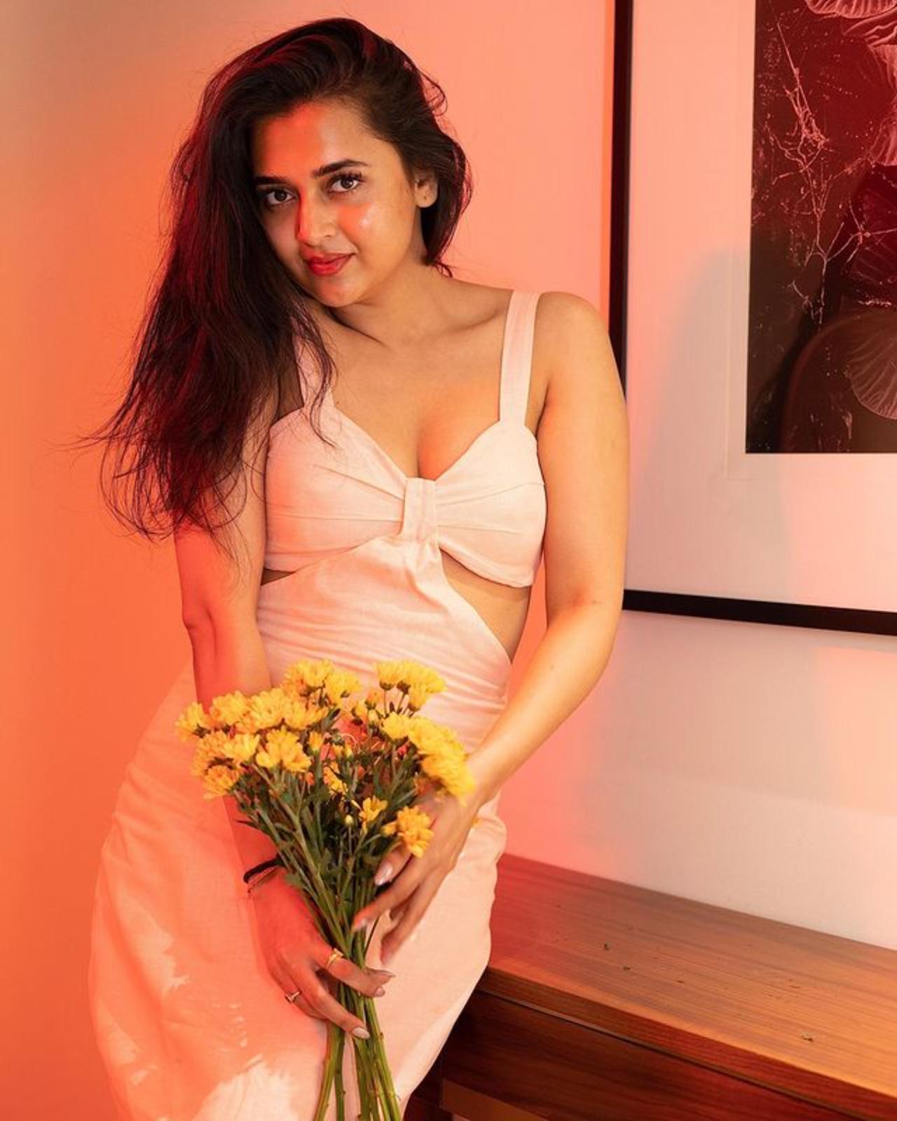 Tejasswi in this picture poses with some sunflowers which definitely made this picture much more beautiful