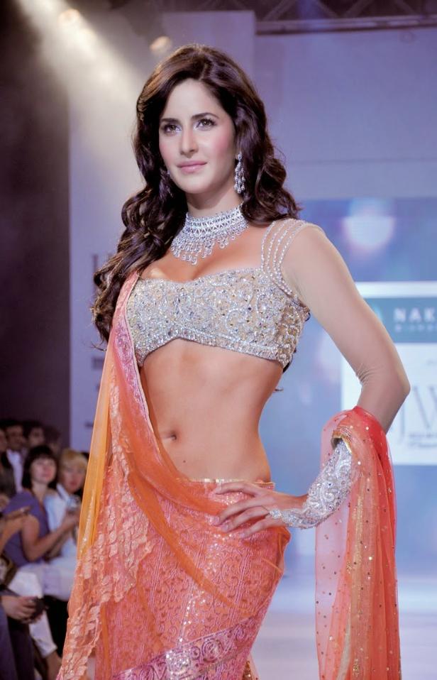 Radiating grace in a salmon pink lehenga, Katrina Kaif steals the spotlight. The intricately silver embroidered top and dazzling jewels make her shine like a true diva