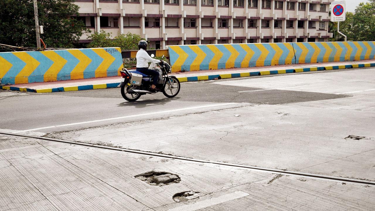 Potholes are visible on the Kopri rail overbridge on Monday