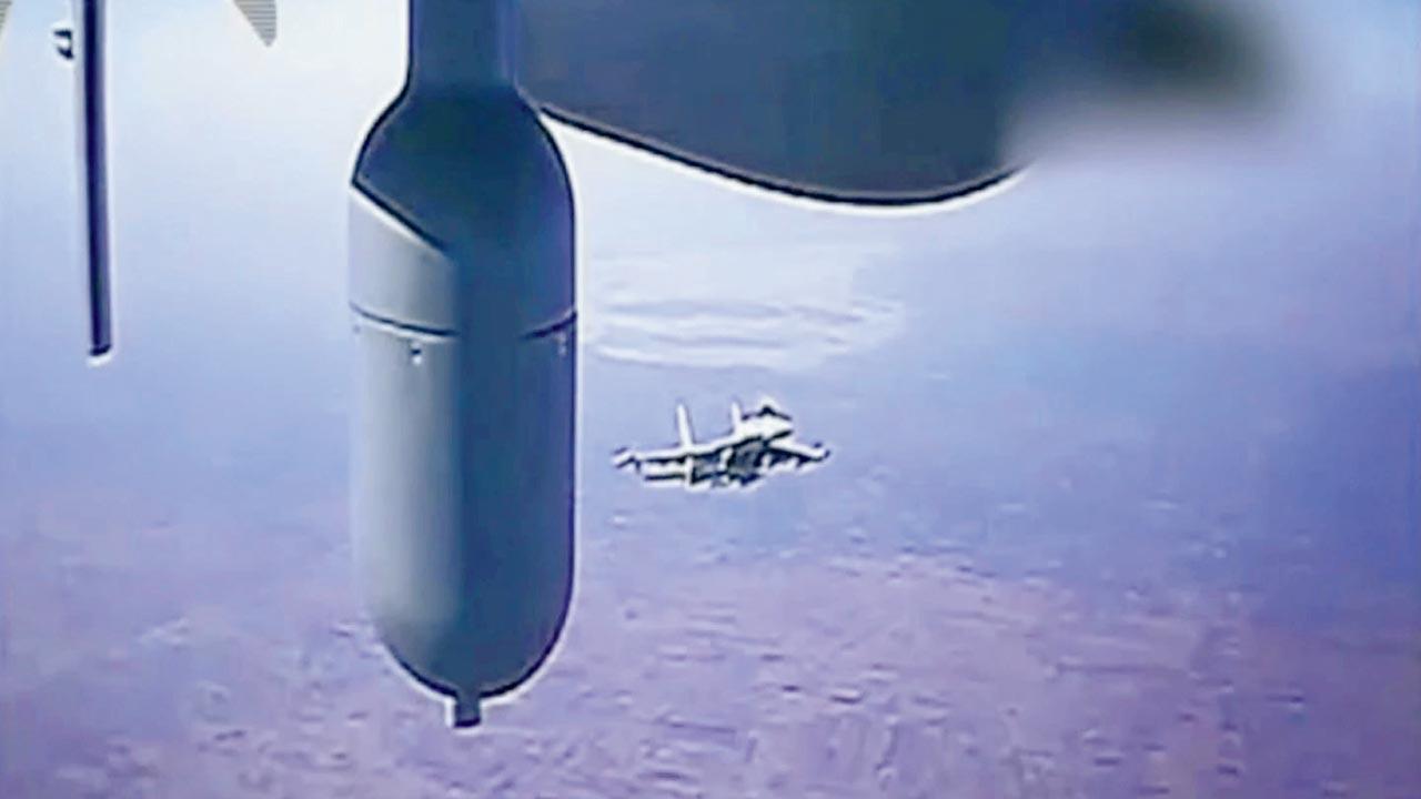 A Russian jet flies close to a US MQ-9 drone on July 23. Pic/AP 