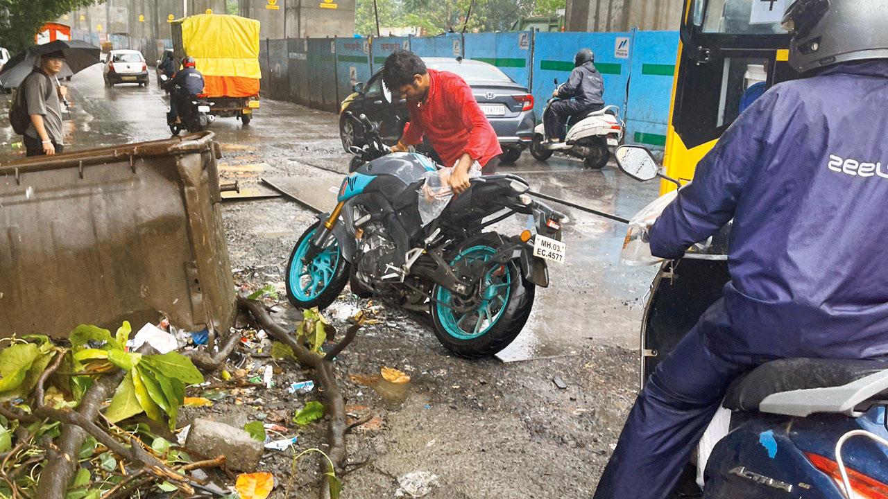 A biker gets up after slipping on the stretch. Pic/Rian Khorana