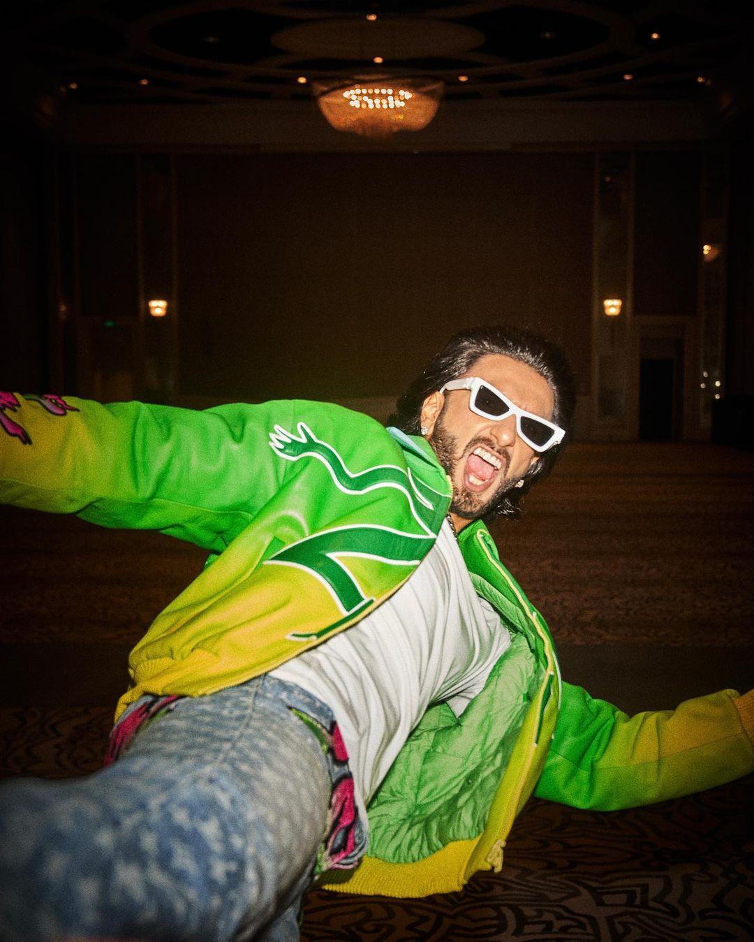 The highlight of his ensemble was an ombre green and yellow jacket, featuring a striking print of an enigmatic black tiger on the back