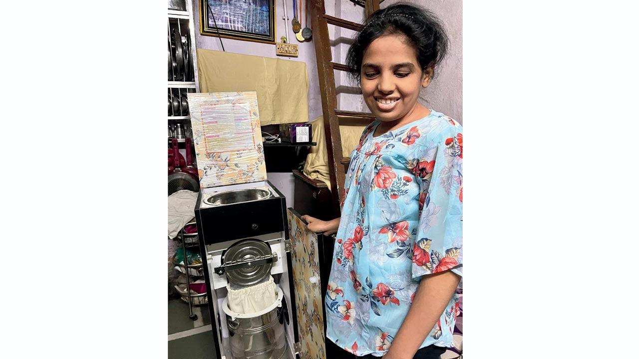 Prachi Gobde with the aata chakki machine she received