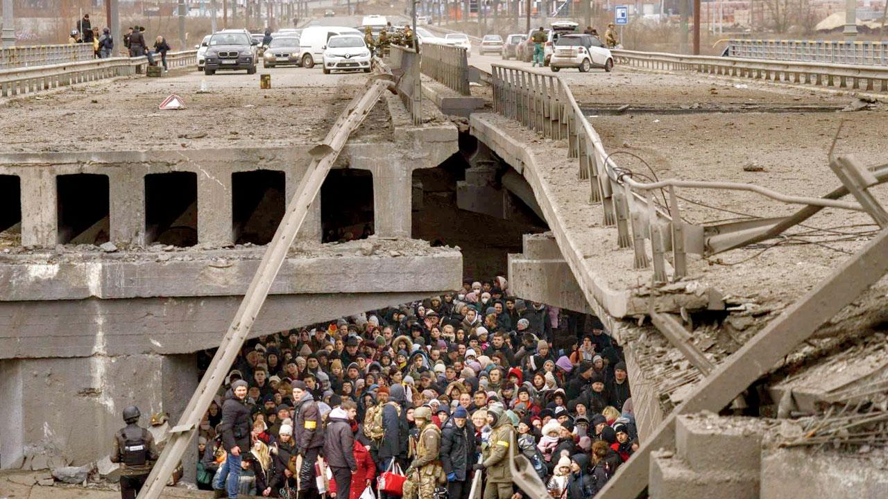 People take cover under a bridge near Kyiv